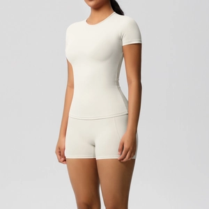 Close-up of off-white brushed fabric textures on a tight-fitting yoga and fitness set