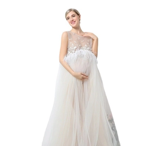 White lace maternity photography dress with feather trim and sheer mesh floor-length skirt