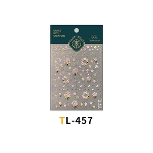 Macro detail of French floral nail art stickers with gold foil accents and heart motifs