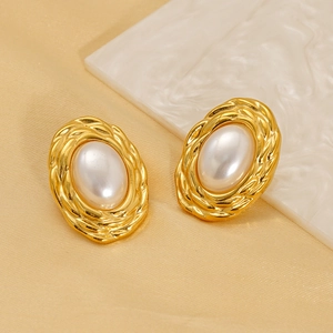 Elegant gold oval pearl earrings with woven metal texture on premium satin background