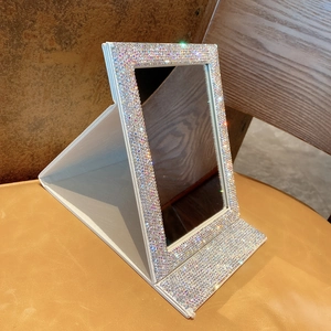 Detail view of foldable tabletop makeup mirror with sparkling white rhinestones