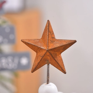 Retro rusty metal star ornament with industrial style on wooden stand for desk decor