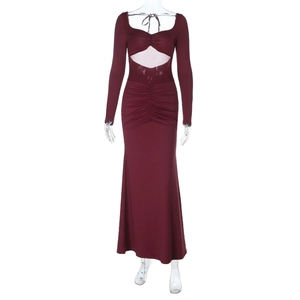Close-up of wine red slim fit dress with waist cut-out and detailed ruched fabric texture