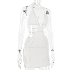 Detail of white hollow-out knitted dress showing delicate texture and halter neck design