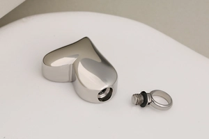 Macro detail of polished stainless steel heart urn pendant with screw cap and waterproof seal