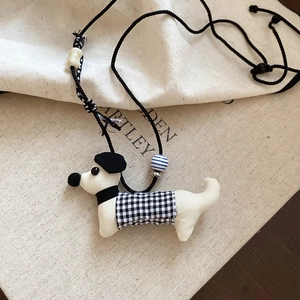 Detail of dachshund pendant necklace with handmade fabric texture and plaid vest style