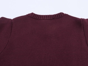 Close-up of the ribbed crew neck and fine knit texture of the dark purple top
