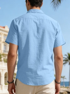 Detail of light blue linen shirt back showing breathable fabric texture in summer resort