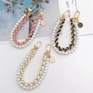 Dual-layer faux pearl and leather chain phone wristlet with camellia metal charm