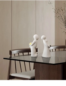 Detail of minimalist white ceramic couple statues with matte finish for home decor