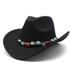 Detail of bohemian black fedora with rainbow woven band and natural shell accents