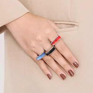 Detail of luxury gold stainless steel rings with colorful square glass stones on hand