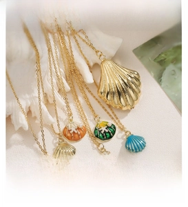 Detailed view of colorful enamel shell pendants on gold necklaces with ocean beach theme