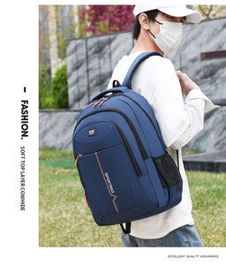 Detail of dark blue sports backpack featuring multiple zipper layers and side mesh pockets