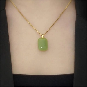 Elegant emerald green rectangular pendant necklace on a delicate gold chain for women