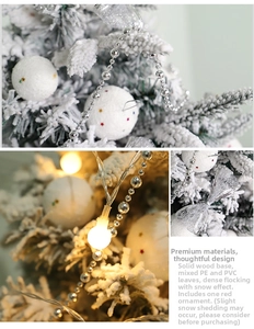 Detailed view of snowy PE flocked Christmas tree with solid wood base and red ornaments