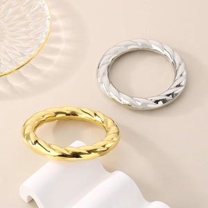 Polished stainless steel twisted bangles in gold and silver finish for women