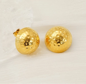 Macro detail of 18K gold-plated hammered texture on round stainless steel stud earrings
