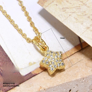 Macro detail of 18k gold plated copper star pendant with white zircon on a 45cm chain