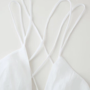Sexy white backless mini dress with thin straps and a puffy skirt for summer beach wear