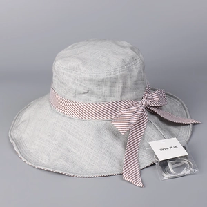 Close-up of light grey sun hat with striped bow and windproof rope accessory