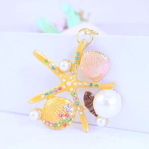 Golden starfish keychain with pearls and crystals, creative ocean theme bag accessory