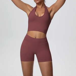 Detail of high-waist ribbed yoga shorts and halter top in mauve seamless knit fabric