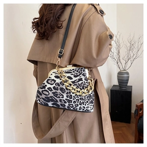Detail of leopard print shell bag with gold chain strap and vintage metal clasp closure