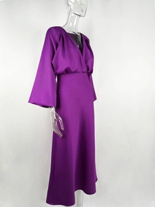 Detail of the purple satin maxi dress with a deep V-neck and elegant draped long sleeves