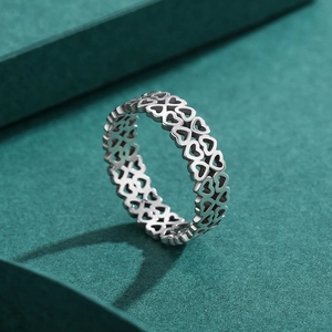 Anello cuore traforato in argento sterling S925 retrò su sfondo carta verde
