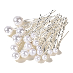 Detailed view of elegant white artificial pearls on silver metal bridal hair pins