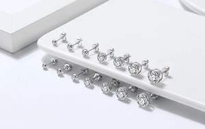 Detailed grid of S925 sterling silver round zirconia studs in various sizes on a tray