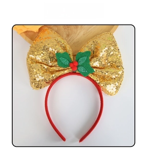 Close-up of golden sequin Christmas bow headband with red berries and green holly leaves