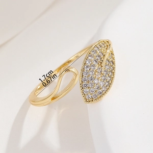 Detailed view of 18K gold adjustable leaf ring with sparkling cubic zirconia inlay