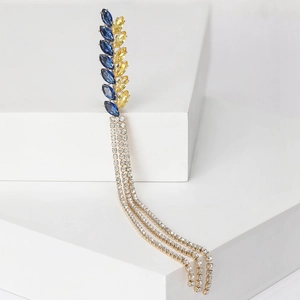 Detail of wheat ear brooch with blue and yellow gems and sparkling crystal tassels