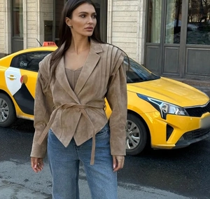Détails de la veste en daim kaki avec épaules plissées et ceinture à nouer à la taille