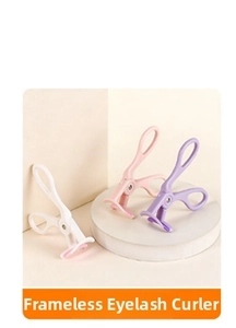 Close-up of pink, purple and white frameless eyelash curlers on a beige display stand