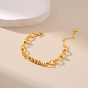 Detail of 18K gold plated thick O-chain bracelet with textured beads and lobster clasp