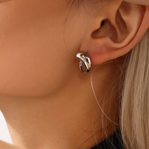 Polished silver teardrop earrings with organic fluid design shown on a female model