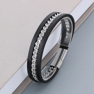 Detail of black woven leather and silver stainless steel chain with a magnetic buckle