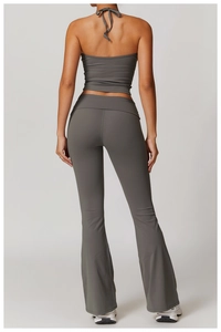 Back view of a grey halter neck sports bra and high-waisted flared yoga pants set