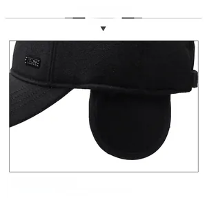 Close-up of black winter baseball cap with ear flaps and metallic detail on fabric