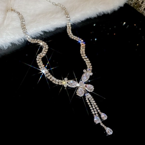 Detail of vintage silver tone bow pendant with teardrop crystals and double row chain