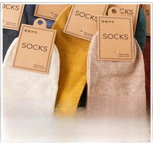 Macro detail of men's combed cotton socks in retro colors with card packaging