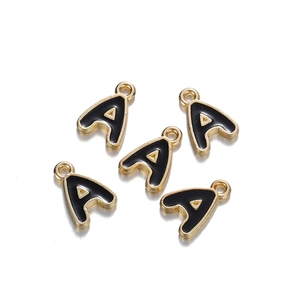 Detail of five gold-plated enamel letter A charms for DIY jewelry making and crafts
