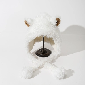 Detail of white plush earflap hat with brown 3D animal ears and large pom-pom tassels