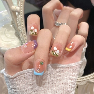 Detailed view of handmade press-on nails with 3D rhinestones and floral painted accents
