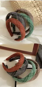 Detailed view of handmade textured wool padded headbands in various autumn colors
