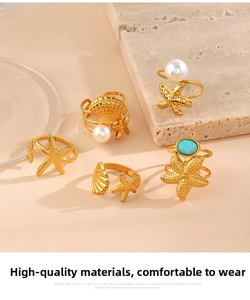 Detail of five-piece gold ring set featuring starfish, shells, pearls and turquoise stones