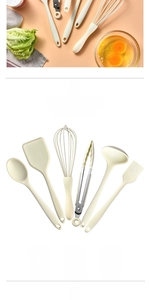 Close-up of heat-resistant silicone kitchen utensil set in cream white including spatula and whisk